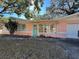 Pink house with teal door and large windows, situated on a grassy lot at 6035 Grand Blvd, New Port Richey, FL 34652