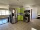 Galley kitchen with stainless steel appliances and green cabinets at 6035 Grand Blvd, New Port Richey, FL 34652
