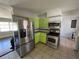 Stainless steel appliances and light green cabinets in a galley kitchen at 6035 Grand Blvd, New Port Richey, FL 34652