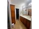 Bathroom with double vanity and large walk-in closet at 703 Old Charleston Way, Largo, FL 33770