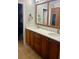 Double vanity bathroom with ample storage and large mirror at 703 Old Charleston Way, Largo, FL 33770