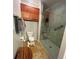 Full bathroom with walk-in shower and linen storage at 703 Old Charleston Way, Largo, FL 33770