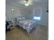 Guest bedroom with a queen bed, desk, and ceiling fan at 703 Old Charleston Way, Largo, FL 33770