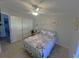 Bright bedroom with a double bed, desk, and ample closet space at 703 Old Charleston Way, Largo, FL 33770