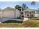 Gray house with attached garage and screened porch at 703 Old Charleston Way, Largo, FL 33770