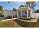 Gray house with attached garage and screened porch at 703 Old Charleston Way, Largo, FL 33770