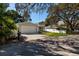 House exterior view, driveway, and street at 703 Old Charleston Way, Largo, FL 33770