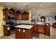 Kitchen with island, stainless steel appliances, and wood cabinets at 703 Old Charleston Way, Largo, FL 33770