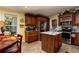 Kitchen with island, stainless steel appliances, and wood cabinets at 703 Old Charleston Way, Largo, FL 33770
