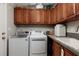 Bright laundry room, washer, dryer, and ample cabinetry at 703 Old Charleston Way, Largo, FL 33770