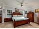 Main bedroom with wood furniture and ceiling fan at 703 Old Charleston Way, Largo, FL 33770