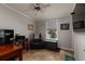Home office featuring a comfortable recliner, desk, and built-in shelving at 703 Old Charleston Way, Largo, FL 33770