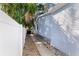 Landscaped side yard with a walkway and privacy fence at 703 Old Charleston Way, Largo, FL 33770