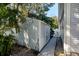 Side yard with shed, landscaping, and a walkway at 703 Old Charleston Way, Largo, FL 33770
