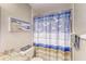 Bathroom with granite countertop, updated vanity, and a blue shower curtain at 9719 Pleasant Run Way, Tampa, FL 33647