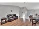 Inviting living room featuring hardwood flooring, a leather couch, and an open layout at 9719 Pleasant Run Way, Tampa, FL 33647