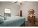 Bright bedroom with a ceiling fan and antique wooden dresser at 11201 Kerry Hills Ct, Riverview, FL 33569