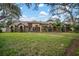 Brick house with a large front yard, walkway, and palm trees at 11201 Kerry Hills Ct, Riverview, FL 33569