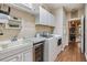 Bright laundry room with washer, dryer, and cabinets at 10190 Hyannisport Loop, San Antonio, FL 33576