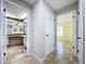 Hallway with tile floors and access to bedrooms and bathrooms at 1029 Fuchsia Dr, Holiday, FL 34691