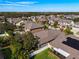 Overhead view of a residential neighborhood featuring well-maintained homes, lush landscaping, and tree-lined streets at 11409 Drifting Leaf Dr, Riverview, FL 33579
