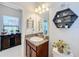 Small bathroom with granite vanity, toilet and decorative accents at 11409 Drifting Leaf Dr, Riverview, FL 33579