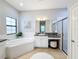 Elegant bathroom with soaking tub, granite vanity and a separate shower at 11409 Drifting Leaf Dr, Riverview, FL 33579