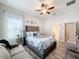 Bright bedroom with a comfy bed, ceiling fan, and plenty of natural light at 11409 Drifting Leaf Dr, Riverview, FL 33579