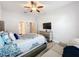Spacious bedroom with a queen-size bed, dresser, and ceiling fan at 11409 Drifting Leaf Dr, Riverview, FL 33579