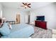 Primary bedroom with a large bed, dresser, and access to the bathroom at 11409 Drifting Leaf Dr, Riverview, FL 33579