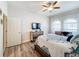 Spacious bedroom with a ceiling fan, large windows, and ample closet space at 11409 Drifting Leaf Dr, Riverview, FL 33579