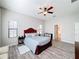 Main bedroom with a large bed, dresser and access to the bathroom at 11409 Drifting Leaf Dr, Riverview, FL 33579