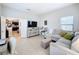 Gathering room features a sectional sofa, TV, and built-in shelving at 11409 Drifting Leaf Dr, Riverview, FL 33579