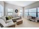 Relaxing Gathering room with a comfortable sectional sofa and large windows at 11409 Drifting Leaf Dr, Riverview, FL 33579