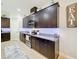 Modern kitchen with dark cabinets, granite countertops, and stainless steel appliances at 11409 Drifting Leaf Dr, Riverview, FL 33579