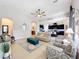 Living room with open concept to kitchen, featuring neutral colors and ample natural light at 11409 Drifting Leaf Dr, Riverview, FL 33579