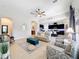 Bright living room with a comfortable couch and chairs, open to the kitchen at 11409 Drifting Leaf Dr, Riverview, FL 33579