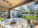Covered patio with fire pit and seating area overlooking the backyard at 11409 Drifting Leaf Dr, Riverview, FL 33579