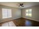 Spacious bedroom with ample natural light and wood-look tile floors at 1151 Pine Ridge W Cir # H1, Tarpon Springs, FL 34688