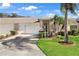 Brick house with attached garage, well-manicured lawn, and palm trees at 1228 Flora Vista St, Trinity, FL 34655