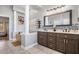 Spacious bathroom with double vanity, mosaic backsplash, tub, and bright lighting at 12306 Woodlands Cir, Dade City, FL 33525