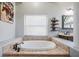 Luxurious bathroom showcasing a tub with tile surround, and a window with natural light at 12306 Woodlands Cir, Dade City, FL 33525