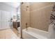 Bathroom featuring a bathtub with tiled walls, toilet, vanity with granite countertop and walk-in shower at 12306 Woodlands Cir, Dade City, FL 33525