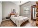 Bedroom with wood flooring, Queen bed, decorative pillows and a wardrobe at 12306 Woodlands Cir, Dade City, FL 33525