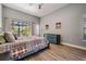 Comfortable bedroom with wood floors, dresser, and a sliding glass door to the outdoor space at 12306 Woodlands Cir, Dade City, FL 33525