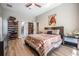 Bright bedroom featuring wood floors, walk-in closets, and neutral walls at 12306 Woodlands Cir, Dade City, FL 33525