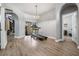 Open bonus room with wood-look floors, slider to lanai, and arched doorways at 12306 Woodlands Cir, Dade City, FL 33525