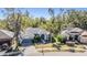 Charming single-Gathering home boasting mature trees, lush landscaping, and a well-maintained exterior at 12306 Woodlands Cir, Dade City, FL 33525