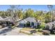 Inviting single-Gathering home with a well-manicured lawn, mature trees, and a two-car garage at 12306 Woodlands Cir, Dade City, FL 33525