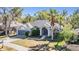 Charming single-Gathering home with manicured lawn, two car garage, and arched entryway at 12306 Woodlands Cir, Dade City, FL 33525